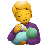 Людина годує немовля