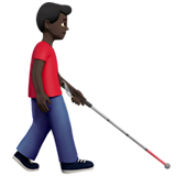 Мужчина с белой тростью смотрит вправо: темный оттенок кожи для Apple iOS 18.4