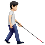 Людина з білою тростиною дивиться праворуч: світлий тон шкіри для Apple iOS 18.4